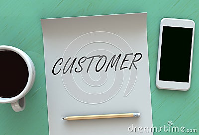 CUSTOMER, message on paper, smart phone and coffee on table Stock Photo