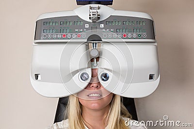 Customer of a optometrist or optician looking through phoropter Stock Photo