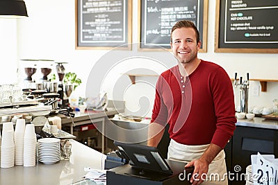 Customer Paying In Coffee Shop Using Touchscreen Stock Photo