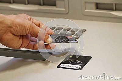 A customer paying using contactless credit cards payment system. Editorial Stock Photo