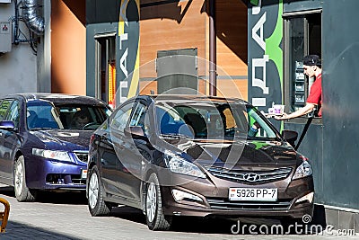 Minsk, Belarus, April 20, 2018: Customer receiving order from McDonald`s drive thru service Editorial Stock Photo