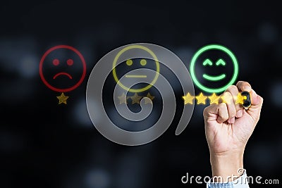 Customer satisfaction service and product concept , Businessman drawing gold star with smile face to submit evaluation scorecard Stock Photo