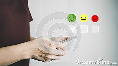 Customer satisfaction very good service with smart phone, impression of take care and attention, choose a smiley face icon, answer Stock Photo