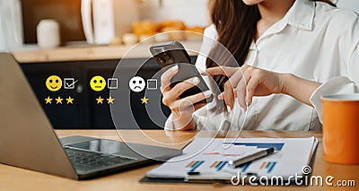 Customer service evaluation concept. Businesswoman pressing face smile emoticon show on virtual screen at tablet and smartphone Stock Photo