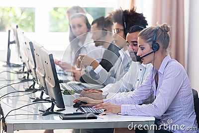 Customer Service Executives Working In Call Center Stock Photo