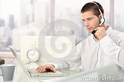 Customer service operator working in bright office Stock Photo