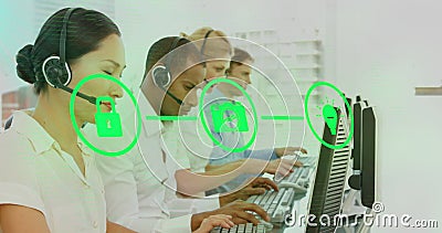 Customer service team using headsets and computers, focusing on digital security Stock Photo