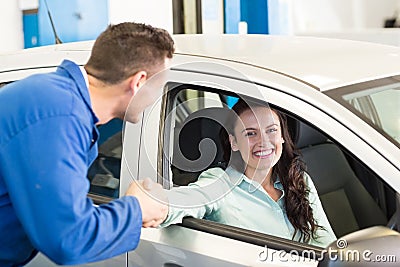 Customer shaking hands with mechanic Stock Photo