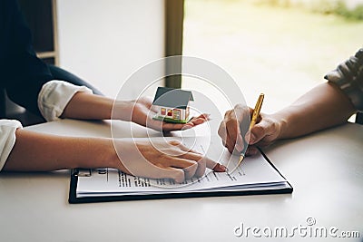 Customer signing a paper document for buying house. Estate agent Stock Photo