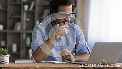 Young male student in headset confer with teacher online Stock Photo