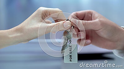 Customer taking keychain from businessman, house for sale, real estate broker Stock Photo