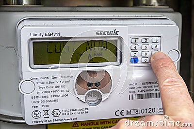 Gas meter being checked, UK. Cost now message Editorial Stock Photo