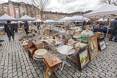 Customers of flea market looking for bargains and antique stuff in mess of vintage decor and retro details Editorial Stock Photo