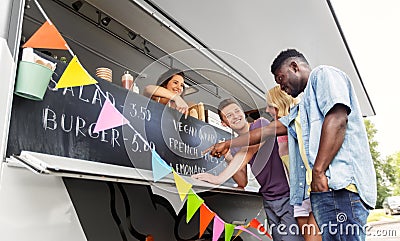 Customers or friends and saleswoman at food truck Stock Photo