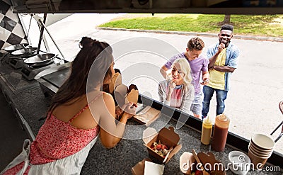 Customers queue and saleswoman at food truck Stock Photo