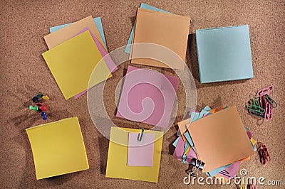 Customizable blank post-its and office supplies on cork message board Stock Photo