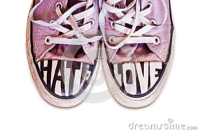 Customized used pink sneakers with words hate and love Stock Photo