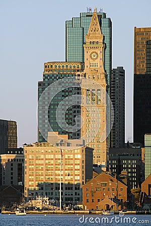 The Customs House Clock Tower and Boston skyline at sunrise, as seen from South Boston, Massachusetts, New England Editorial Stock Photo