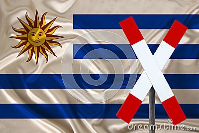 Customs sign, stop, attention on the background of the silk national flag of the country of Uruguay, the concept of border and Stock Photo