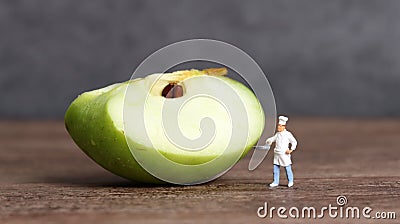 A cut apple and miniature people. Stock Photo