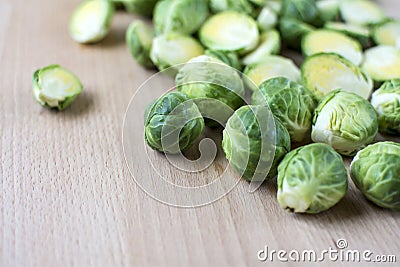 Cut brussels sprout lay flat on wooden board Stock Photo
