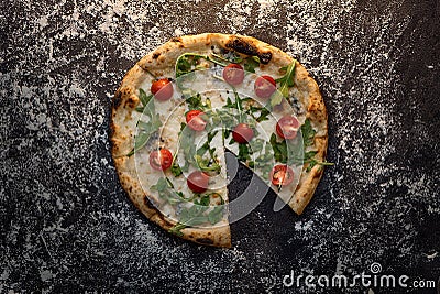 Cut cheese pizza with flour on dark wooden background top view Stock Photo