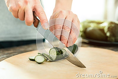 Cut fresh cucumber being under the knife. Stock Photo