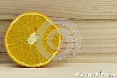 Cut fresh juicy natural sour orange on wooden background Stock Photo
