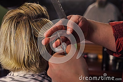 Cut hair. Barber making hairstyle for bearded man barbershop background. Hipster client getting haircut. Barber scissors Stock Photo