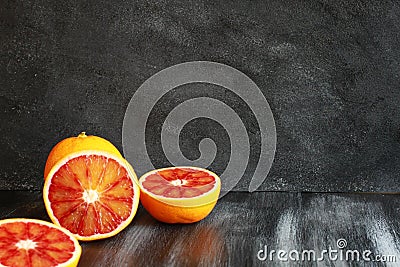 Half blood oranges on dark table Stock Photo