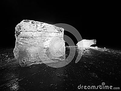 Cut ice. Crushed cubes lighted with strong backlight. Silent bay with flat frozen level. Stock Photo