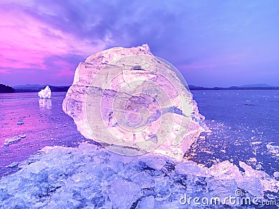 Cut ice. Crushed cubes lighted with strong backlight. Silent bay with flat frozen level. Stock Photo