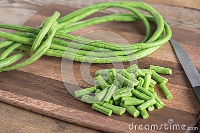 Cut of long bean on wood cutting board. Selective focus. Stock Photo