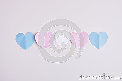 cut out colored paper hearts on gray background, transexual colors, lgbt pride concept Stock Photo