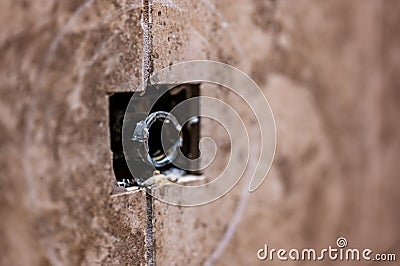 Cut-out section in bathroom shower tile with pipe connection protruding for water hookup. Stock Photo