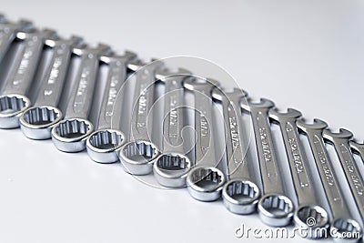 Cut-out wrenches horizontally placed from the biggest to the smallest in a row. Top view composition. Hand tool. Tools Stock Photo