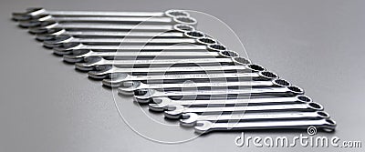 Cut-out wrenches horizontally placed from the biggest to the smallest in a row. Top view composition. Hand tool. Tools Stock Photo
