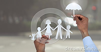 Cut outs family under protective umbrella Stock Photo