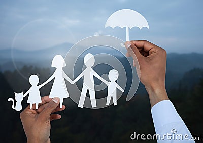 Cut outs family under protective umbrella with landscape Stock Photo