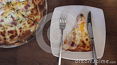 Cut into slices delicious fresh pizza on a dark wooden table background Stock Photo
