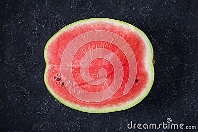 Cut watermelon on a darkgrey background. Stock Photo