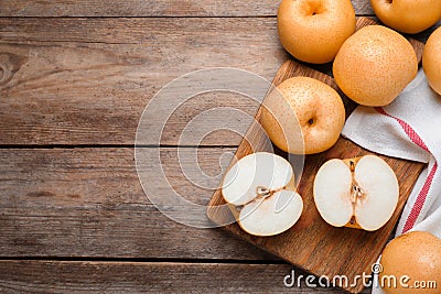 Cut and whole apple pears on wooden table, flat lay. Space for text Stock Photo