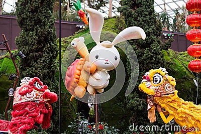 Cute and adorable cartoon-like rabbit and turtle emerging from flowers at gardens by the bay Editorial Stock Photo