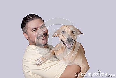 Cute and adorable scene of a man carrying around his spoiled mid-sized adult dog on his shoulders. Isolated on a white background Stock Photo