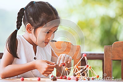 Cute asian child girl playing and creating with play dough Stock Photo
