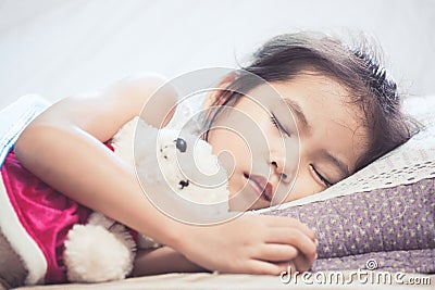 Cute asian child girl sleeping and hugging her teddy bear Stock Photo