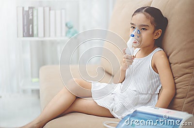 Child patient inhalation therapy by the mask of inhaler with soft stream smoke from bronchodilator. Stock Photo