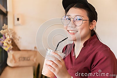 Cute Asian fat plus size girl teen drinking ice coffee Stock Photo