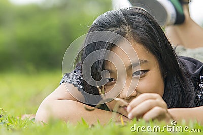 Cute asian girl laying on the grass Stock Photo