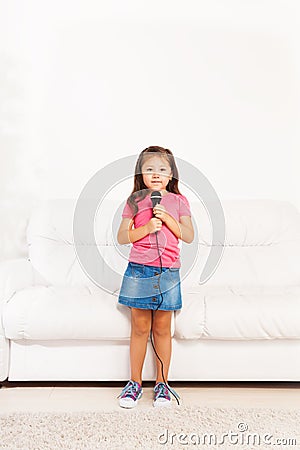 Cute Asian girl with microphone Stock Photo